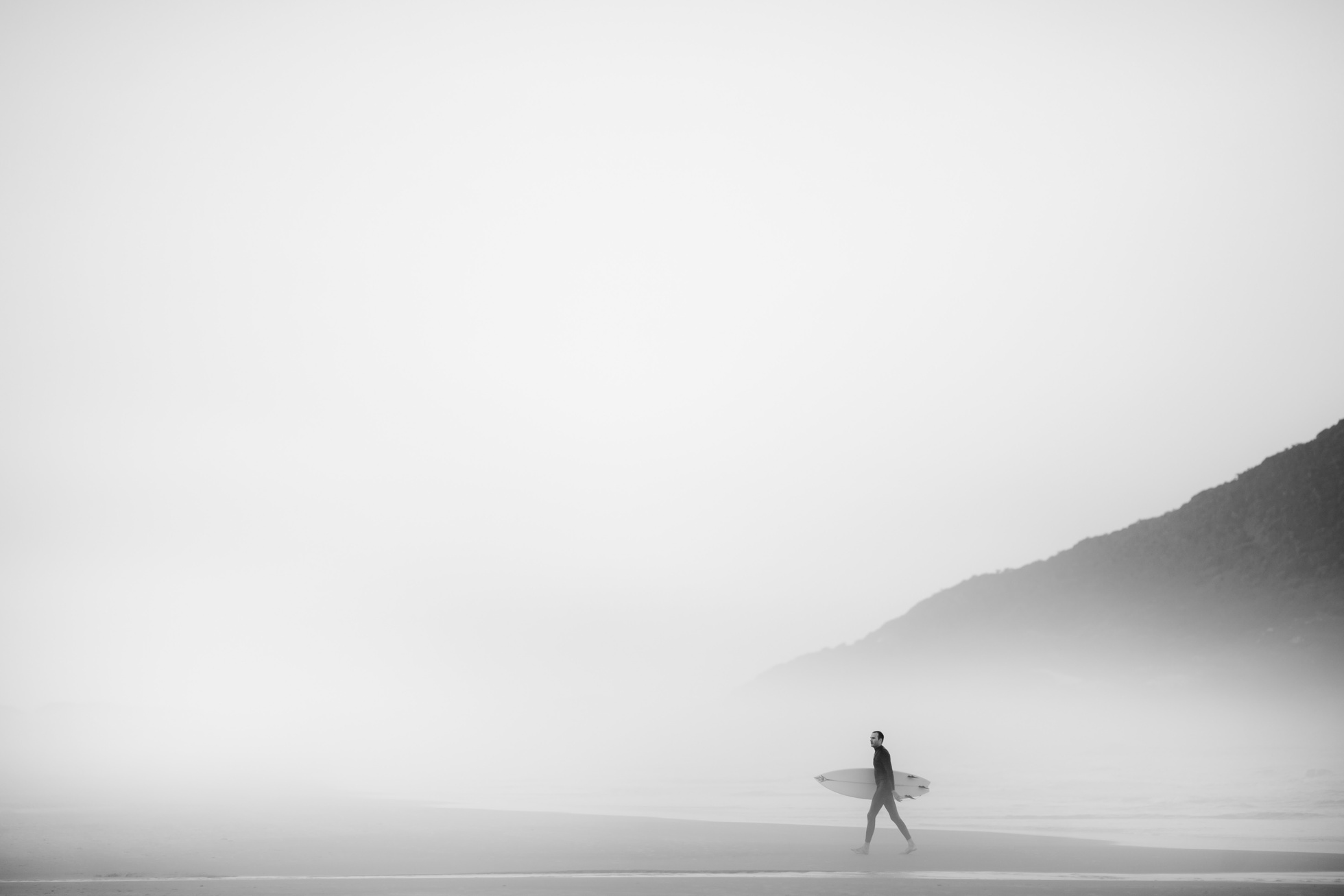 Man Holding Surf Board near the Beach